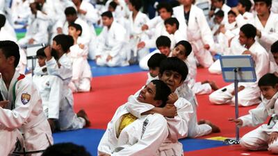 Students from Abu Dhabi Education Council schools attempt to break the world record for the largest jiu-jitsu class at the Abu Dhabi National Exhibition Centre. Christopher Pike / The National