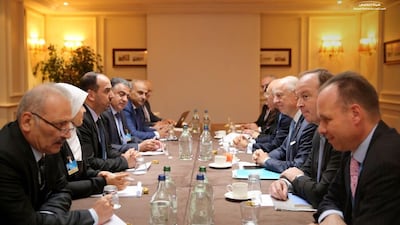 Members of the unified Syrian opposition delegation meet with UN officials in Geneva on November 29, 2017 on the first day of the eighth round of UN-brokered peace talks. High Negotiations Committee