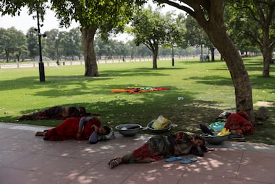 Women labourers rest under a tree on a hot day near India Gate in New Delhi. Reuters