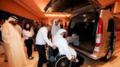 Driver Anil Kumar helps Abdullah Al Saad, a senior administrative officer with the Department of Transport, into one of the six Dh250,000 Mercedes vans, which are equipped with wheelchair lifts and high roofs. Sarah Dea / The National