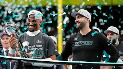 Philadelphia Eagles quarterback Jalen Hurts, left, holds the Vince Lombardi Trophy. AP