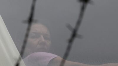 Renata Voracova of the Czech Republic looks out a window at the Park Hotel in Melbourne where she is being held following the cancellation of her visa. Reuters