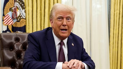 US President Donald Trump sits in the Oval Office of the White House on January 23. Reuters