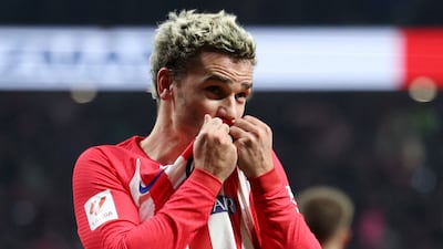 Antoine Griezmann kisses the Atletico Madrid badge after scoring against RCD Mallorca. Reuters