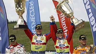 Mikko Hirvonen, centre right, celebrates taking the Rally of Poland with his co-driver Jarmo Lehtinen. The win puts the Finn first in the overall championship standings.