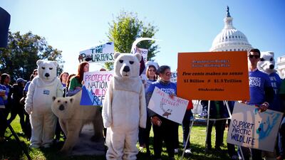 Activists attend a protest against the legislation that would allow drilling in the Arctic National Wildlife Refuge, an area Mr Biden promised to protect during his presidential campaign. Reuters