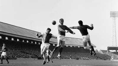 Denis Law clears the ball from Andy McEvoy at Ewood Park in 1965. Getty