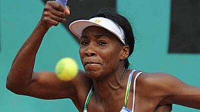 Venus Williams returns the ball during her defeat to the Hungarian No 29 seed Agnes Szavay.