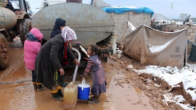 Syrian refugees, fled their homes due to the attacks of Assad's forces, try to hold on life under harsh living conditions at the Atmeh refugee camp in Idlib, Syria on January 11, 2015. Anadolu Agency/Getty Images