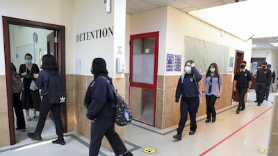 Pupils of grade 11 go to their class on the first day of the school reopening in 2020. Pawan Singh / The National