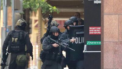 Armed police are seen outside the Lindt Cafe, Martin Place in Sydney, Australia. (Photo by Mark Metcalfe/Getty Images)