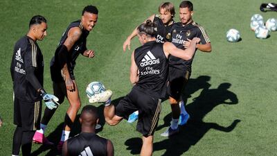 Gareth Bale, centre, controls the ball next to his teammates. EPA