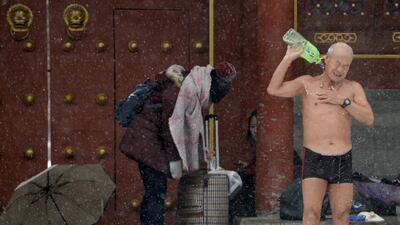 A winter swimmer pours water on his body to clean up after swimming in the Shichahai Lake amid heavy snowfall in Beijing, China. Snowstorms have swept across a vast area of north China, disrupting traffic, grounding flights and slowing bullet trains in Beijing, Tianjin, Hebei Province and the Inner Mongolia Autonomous Region, Xinhua News Agency reported. China Daily / Reuters