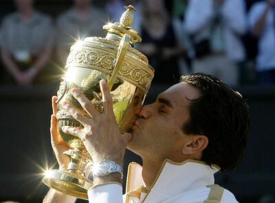 Roger Federer after winning the 2009 Wimbledon title, the sixth of his eight trophies. Reuters