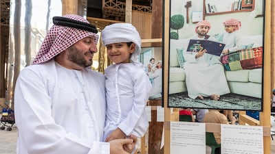 Sultan Karrani with his son Laith next to their photograph.