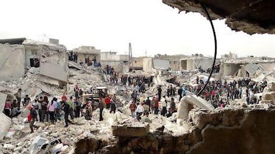 People search the rubble for dead bodies and injured victims at a site were houses were hit by a missile attack by Syrian government forces in Aleppo on Tuesday. Aleppo Media Center AMC / AP Photo