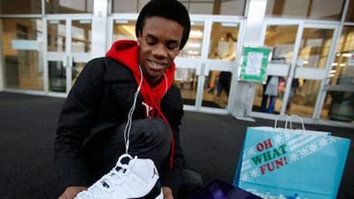 Kristopher Rush, 14, shows off the Nike Air Jordan shoes he got for Christmas. He waited in line with his father and brother for over three hours.