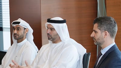 Four years after the Al Etihad Credit Bureau's launch, Marwan Lutfi (centre) its chief executive, says bad debt levels are reducing and and net profits in the banking sector are increasing. Courtesy AECB