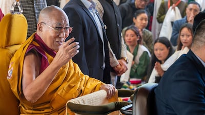 Tibetan spiritual leader the Dalai Lama greets devotees at an event in Dharamshala, India. AP