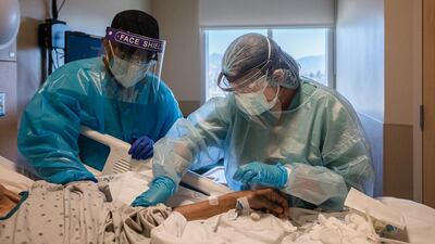 Healthcare workers treat a Covid-19 patient in a Step Down Unit at Providence Holy Cross Medical Center in Mission Hills, California, US. Bloomberg