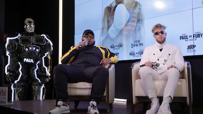 Jake Paul's mascot The Problem Bot looks on as comedian Drew "Druski" Desbordes and Paul speak to reporters. AFP