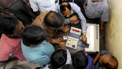 An Indian official demonstrates Electronic Voting Machines procedures to the personnel for election duty in Tripura yesterday. Arindam Dey / AFP