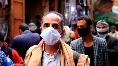 People wear protective face masks against the novel coronavirus at an open-air market in Yemen's rebel-held capital Sanaa. AFP