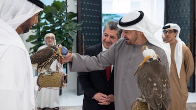 Sheikh Mohamed and Mr Barzani inspect falcons as Sheikh Mansour bin Zayed, Vice President, Deputy Prime Minister and Minister of the Presidential Court, looks on
