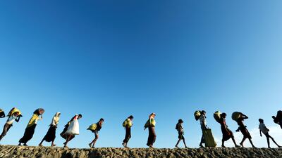 Rohingya refugees arrive at a beach after crossing from Myanmar, in Teknaf, Bangladesh. Jorge Silva / Reuters