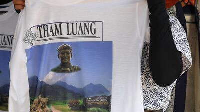 Vendors selling souvenir T-shirts near the entrance of the cave. AFP