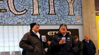 Manchester City fans laugh on Saturday at the Etihad Stadium prior to the Premier League match between Man City and Crystal Palace. Alex Livesey / Getty Images