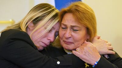 Avivit Yablonka, left, sister of Chanan Yablonka, hugs Orit Meir, mother of Almog Meir, during a press conference at the Israeli embassy in London with family members of seven hostages taken by Hamas. AP