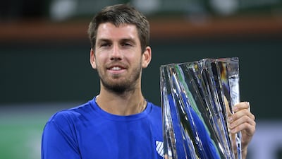 Cameron Norrie of Britain holds the championship trophy after defeating Nikoloz Basilashvili of Georgia in the men’s final at the BNP Paribas Open at the Indian Wells Tennis Garden. Reuters