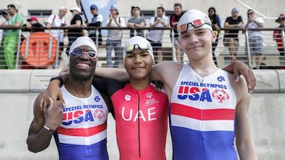 Special Olympics ITU Traiathlon athletes Trent Hampton of Team USA, Micah Hambleton representing the UAE and USA's Chris Vines at the start of the race at YAS Marina Circuit in Abu Dhabi. Victor Besa / The National