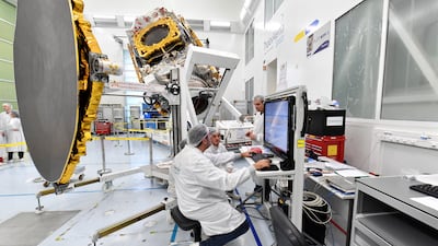 Engineers work on a Eutelsat satellite in Cannes, France. Investors are betting on the company's satellites as the best alternative to Starlink. AFP