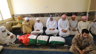 Friends and family pray over the body of Abdullah Al Yamahi, a military pilot who was killed in a helicopter crash on Monday. Mohideen / Aletihad