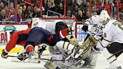 Marty Turco makes a save as teammate Trevor Daley clears the rebound at the Verizon Centre in Washington, DC.