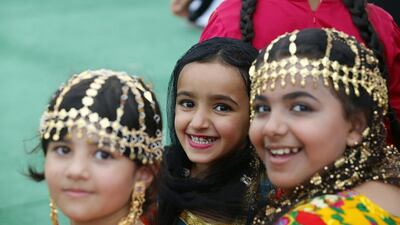 Emirati girls in traditional outfit, usually worn in their village by elderly women. Karim Sahib / AFP