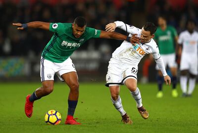 Salomon Rondon of West Bromwich Albion is challenged by Roque Mesa of Swansea City. Michael Steele / Getty Images