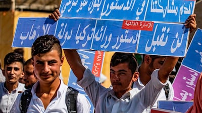 Syrian Kurds demonstrate in front of the United Nations office in the Kurdish-majority city of Qamishli in northeast Syria over their exclusion from the UN-backed constitutional committee. Delil Souleiman / AFP
