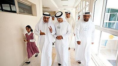 Humaid Mohammad Obaid al Qutami, left, the Minister of Education, and Mugheer Khamis al Khaili, the director general of Abu Dhabi Education Council, centre, visit Al Dhabiania School in Abu Dhabi yesterday.