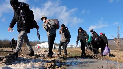 Migrants leave to be relocated from the Lipa camp northwestern Bosnia, near the border with Croatia, Bosnia, Tuesday, Dec. 29, 2020. The European Union on Monday warned Bosnia that thousands of migrants face a winter without shelter, and it urged the country's bickering political authorities to set aside their differences and take action. (AP Photo/Kemal Softic)
