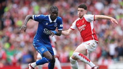 Everton's Amadou Onana surges past Declan Rice. AFP