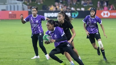 An Al Maha player runs with the ball.