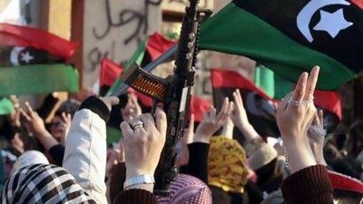 Protesters wave toy guns and the Kingdom of Libya flags during an anti-Qaddafi demonstration in Benghazi.