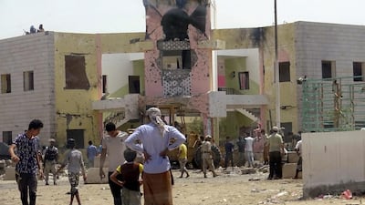 People gather at the scene following an attack by a suicide bomber who drove a car laden with explosives into a school where recruits were waiting to sign up to the army in Aden, Yemen August 29, 2016. REUTERS/Fawaz Salman