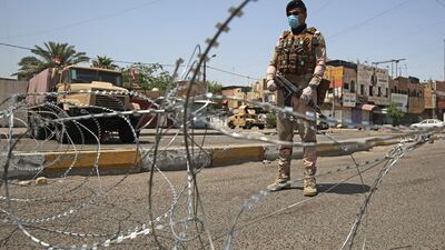 A member of the Iraqi security forces stands guard at a checkpoint in Baghdad's eastern Sadr City suburb. AFP