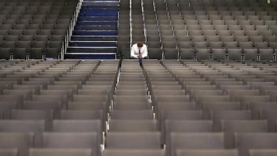 A shareholder waits for the start of the Deutsche Bank shareholders meeting in Frankfurt in 2017. The German lender this week sought to reassure shareholders and its staff after a ratings downgrade by S&P cast doubt on chief executive Christian Sewing's turnaround strategy and initially caused its share price to slump. AP Photo