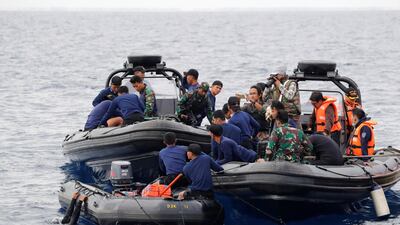 Rescue team members prepare to dive at the location where the flight crashed into the sea. Reuters