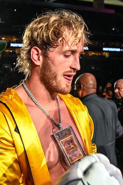 Logan Paul wears a pendant featuring a rare Charizard Pokemon card as he arrives to fight former world welterweight king Floyd Mayweather. AFP